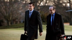 White House staff secretary Rob Porter, left, walks with White House senior adviser Stephen Miller from Marine One across the South Lawn of the White House in Washington, Feb. 5, 2018.