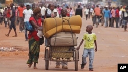 FILE - A family with their belongings on a makeshift trolley in the city of Bangui, Central African Republic, as clashes sectarian clashes erupted between rivaling Christian and Muslim militias, Sept. 30, 2015. 