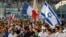 Supporters of Israel’s Gaza offensive wave Israeli and French flags at a demonstration in Marseille, France, July 27, 2014. The radical Jewish Defense League, not shown, uses strong-arm tactics to fight anti-Semitism.