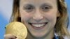 United States' Katie Ledecky shows off her gold medal in the women's 800-meter freestyle medals ceremony during the swimming competitions at the 2016 Summer Olympics, Friday, Aug. 12, 2016, in Rio de Janeiro, Brazil. 