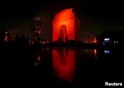 The India Gate war memorial was illuminated in orange Wednesday to commemorate the International Day for the Elimination of Violence Against Women, in New Delhi, India, Nov. 25, 2015.