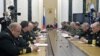 Russian President Vladimir Putin (C) attends a meeting with defence ministry officials in Moscow, May 30, 2012.