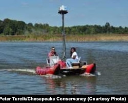 Ryan Abrahamsen, founder of Terrain 360, a virtual river mapping company, on the Patuxent River in Maryland, with passenger.