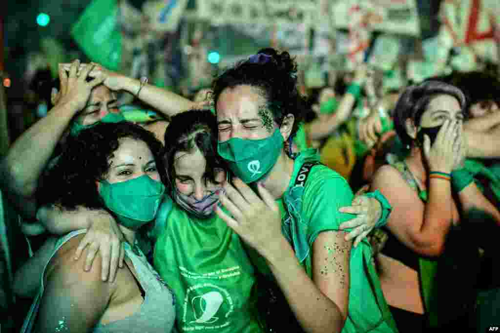 Pro-choice activists celebrate after the Senate approved a bill to legalize abortion, outside the Congress in Buenos Aires, Brazil.