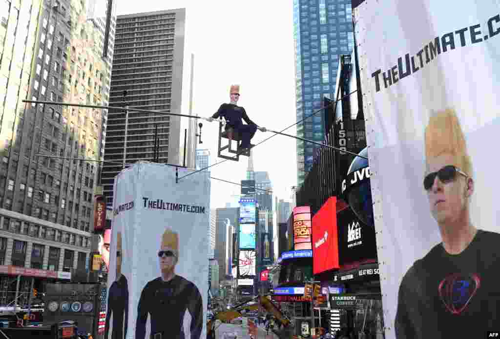 International circus superstar Bello Nock takes over Times Square in New York City as he spends eight hours on a high wire above New Yorkers in the first of several big stunts he is doing this summer.