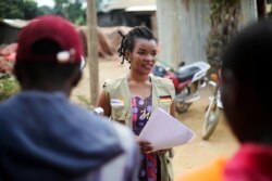Martine Milonde, a Congolese community mobilizer who works with the aid group World Vision in Beni, eastern Congo, engages the public about coronavirus, April 10, 2020.