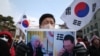 A supporter of impeached South Korean president Yoon Suk Yeol holds a placard of Yoon and incoming U.S. president Donald Trump that translates as “He responded by sending his special regards to the people of South Korea,” in Seoul on Jan. 6, 2025. 