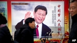 Архів. Люди проходять повз пропагандистський білборд із зображенням президента Китаю Сі Цзіньпіна в Пекіні, Китай, 2 березня 2018 року.