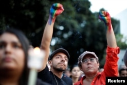 People attend a vigil in memory of victims one day after a mass shooting at the Pulse gay night club in Orlando, in Los Angeles, California, June 13, 2016.