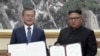 FILE - In this image made from video provided by Korea Broadcasting System (KBS), S. Korean President Moon Jae-in, left, and N. Korean leader Kim Jong Un pose after signing documents in Pyongyang, North Korea Wednesday, Sept. 19, 2018.