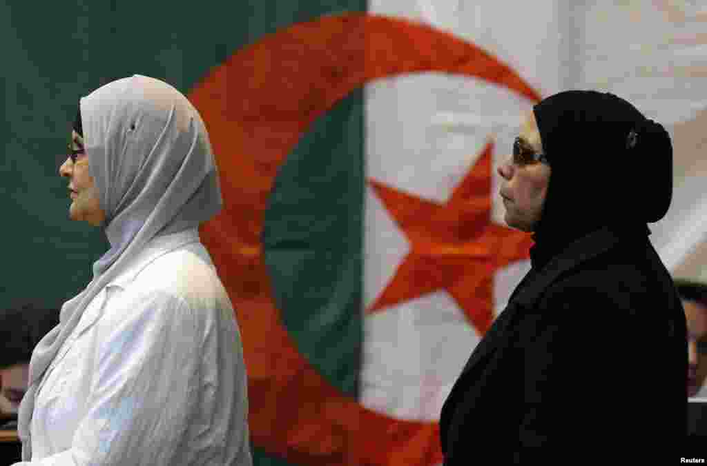 Algerians residing in France prepare to vote, ahead of Algeria&#39;s presidential election, at a polling station in Marseille.