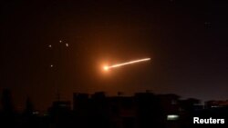 Light in the sky is seen in Damascus, Syria, in this handout released by SANA on February 24, 2020. SANA/Handout via REUTERS SANA February 23, 2020 10:55pm EST