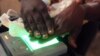 A Congolese official from the electoral commission (CENI) records the fingerprints of a resident during voting registration in Kinshasa, the Democratic Republic of Congo, May 31, 2017.