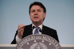 FILE - Italian Premier Giuseppe Conte speaks during a press conference on economic measures to help facing consequences of the virus outbreak, in Rome, March 5, 2020.