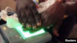 A Congolese official from the electoral commission (CENI) records the fingerprints of a resident during voting registration in Kinshasa, the Democratic Republic of Congo, May 31, 2017.