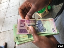 A man in Harare holds bondnotes issued by Reserve Bank of Zimbabwe, Oct. 15, 2018.