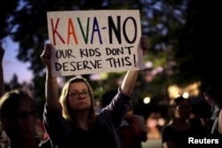 Activists gather outside the U.S. Supreme Court to hold a vigil in opposition to U.S. Supreme Court nominee Brett Kavanaugh in Washington, U.S., Oct. 3, 2018.