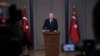 Turkey's President Recep Tayyip Erdogan talks to members of the media at the airport in Ankara, Turkey, before departing for a trip to France, Nov. 10, 2018.