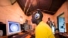 FILE - Young men surf the internet at a cyber cafe in Nairobi's Kibera slum. Taken 6.20.2012 