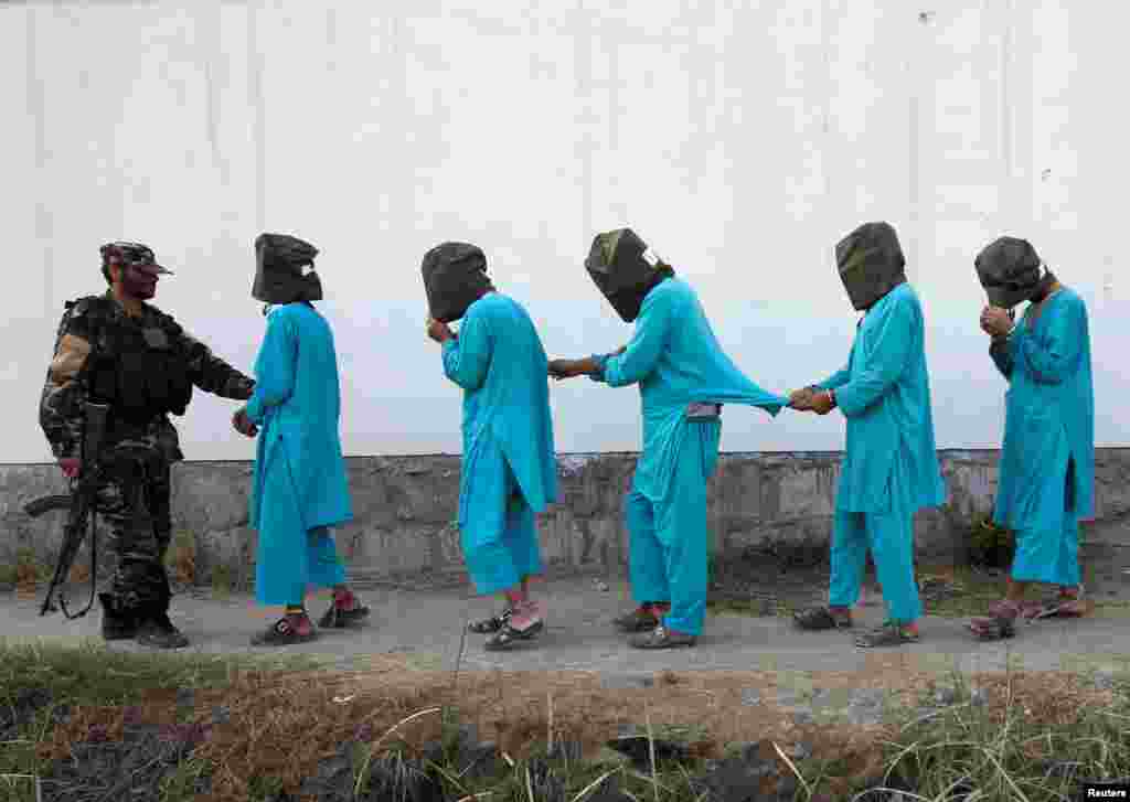 Taliban militants, who were arrested by Afghan security forces, arrive during a presentation to the media in Jalalabad city.