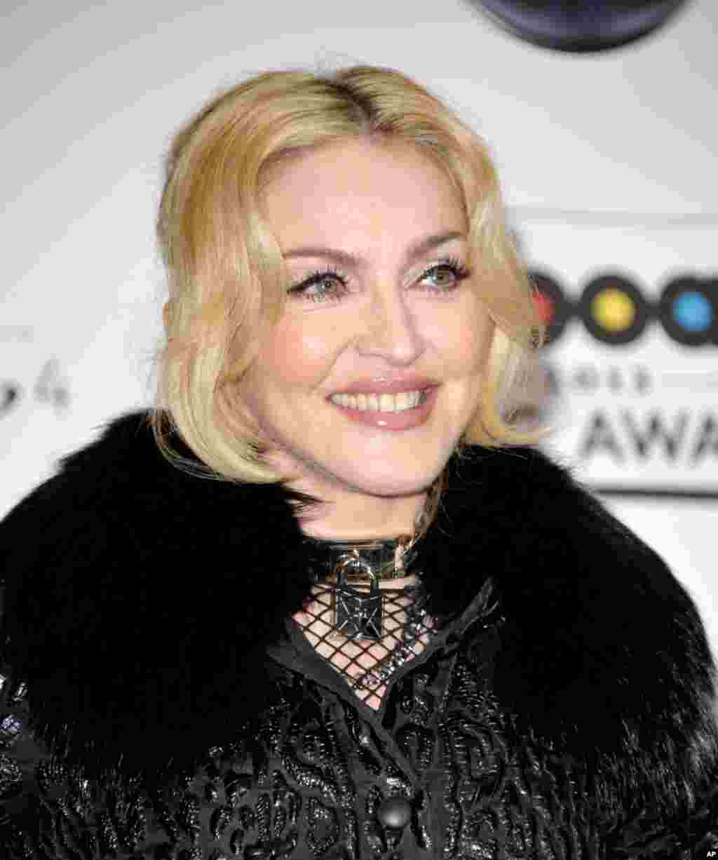 Madonna poses backstage with her awards for top touring artist, dance album and dance artist at the Billboard Music Awards at the MGM Grand Garden Arena in Las Vegas, May 19, 2013.