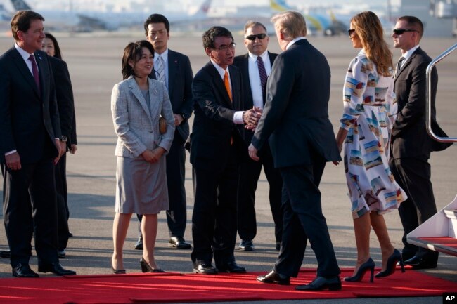 President Donald Trump and first lady Melania Trump are greeted by Japanese Minister of Foreign Affairs Taro Kono and his wife, Kaori Kono, after arriving at Haneda International Airport for a state visit, May 25, 2019, in Tokyo.
