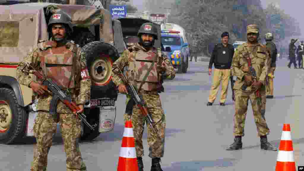 Les troupes de l&#39;armée pakistanaise ont fait un cordon de sécurité sur la route menant à l&#39;école qui a été l&#39;objet d&#39;une attaque des talibans armé sà Peshawar, Pakistan, le 16 décembre 2014.