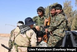 FILE - Fatemiyoun Afghan fighters in Syria