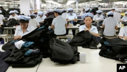 FILE - North Korean workers assemble Western-style suits at the South Korean-run ShinWon Corp. garment factory inside the Kaesong Industrial Complex in Kaesong, North Korea.