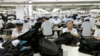 FILE - North Korean workers assemble Western-style suits at a South Korean-run garment factory inside the Kaesong Industrial Complex in Kaesong, North Korea.