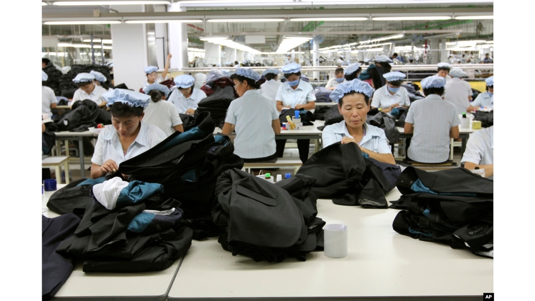 FILE - North Korean workers assemble Western-style suits at the South Korean-run ShinWon Corp. garment factory inside the Kaesong Industrial Complex in Kaesong, North Korea.