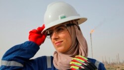 Zainab Amjad, a petrochemical engineer, poses for a photo near an oil field outside Basra, Iraq, Monday, February 18, 2021. (AP Photo/Nabil al-Jourani)