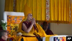 Tibetan spiritual leader the Dalai Lama wears the ceremonial hat of the Gelug school of the Tibetan Buddhism as he prays during his religious talk at the Tsuglakhang temple in Dharmsala, India, March 2, 2018.