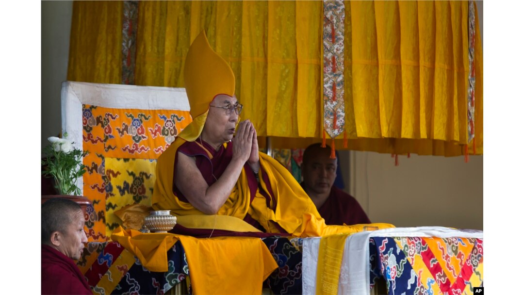 FILE - Tibetan spiritual leader the Dalai Lama wears the ceremonial hat of the Gelug school of the Tibetan Buddhism as he prays during his religious talk at the Tsuglakhang temple in Dharmsala, India, March 2, 2018.