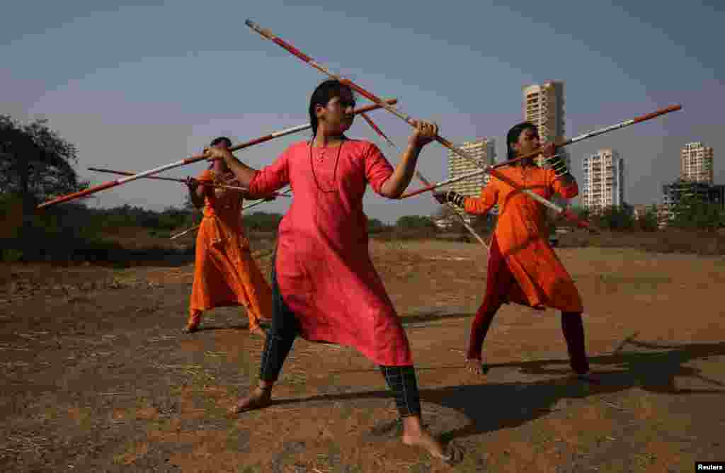 Women practice Shivkalin Yudha Kala, a Maharashtrian martial art on the day before International Women&#39;s Day, at a ground on the outskirts of Mumbai, India.