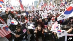 Supporters of South Korean President Park Geun-hye shout slogans during a rally opposing her impeachment near the Constitutional Court in Seoul, South Korea, Friday, March 10, 2017.