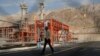 A worker makes his way in a natural gas refinery in the South Pars gas field in Asalouyeh, Iran, on the northern coast of Persian Gulf, Nov. 19, 2015.