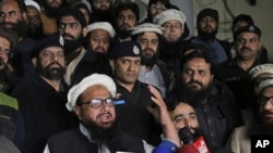 FILE - Hafiz Mohammad Saeed, leader of the Pakistani religious group and charity Jamaat-ud-Dawa, addresses his supporters outside the party's headquarters, in Lahore, Pakistan, Jan. 30, 2017.