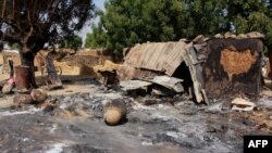 Des maisons en terre battue incendiées par des combattants islamistes de Boko Haram dans le village de Maiborti, à la périphérie de Maiduguri, dans le nord-est du Nigéria, le 17 décembre 2018.