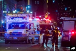 Police and firefighters work near to the scene in Manhattan, New York, Sept. 17, 2016.