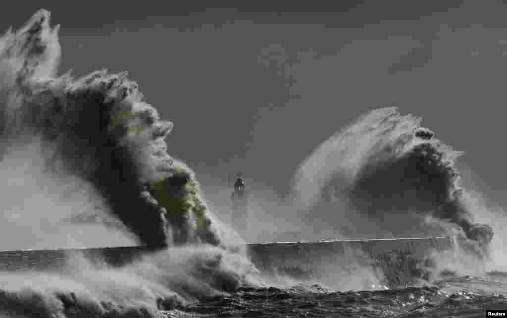Large waves hit the lighthouse and harbor at Newhaven in Sussex, southern England. Britain was hit by a third storm in a week causing damage and compounding the record levels of floodwaters in the south and west of the country.