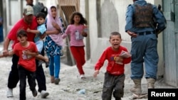 Children run from explosions in busy part of Kabul, May 24, 2013. 