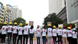 FILE - Demonstrators stand in line as they form a message with their t-shirts during a protest against the military coup in Yangon, Myanmar, February 22, 2021. REUTERS/Stringer/File Photo
