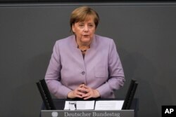 FILE - German Chancellor Angela Merkel delivers her speech about the European Union at the German parliament Bundestag in Berlin, April 27, 2017.