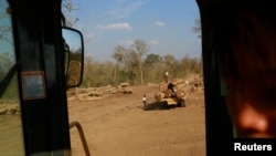 Teak logs are loaded onto a lorry at a logging camp in Pinlebu township, Sagaing division in northern Burma, also known as Myanmar, March 9, 2014.