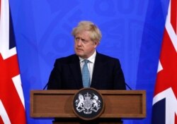 FILE - Britain's Prime Minister Boris Johnson, listens to a question from the media during a press conference about the ongoing coronavirus outbreak, in London, May 14, 2021.