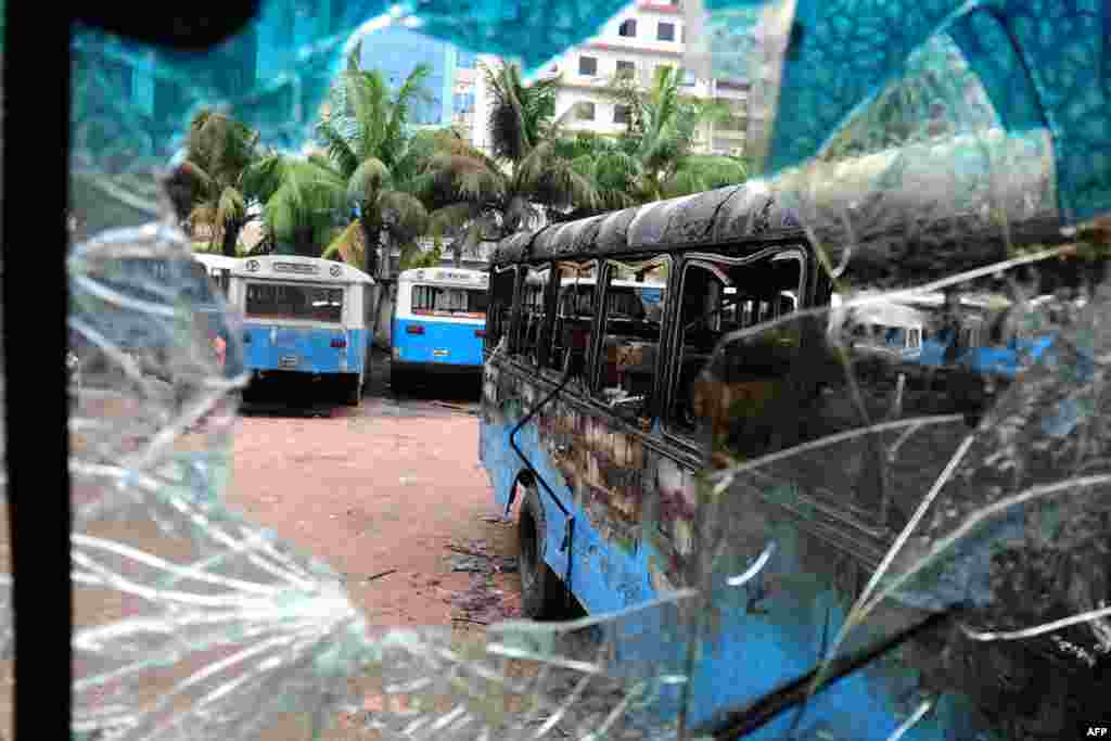 Burnt-out government vehicles are parked following a clash between police and Islamists in Dhaka, Bangladesh. At least 22 people were killed as police fought pitched battles with tens of thousands of hardline Islamists in the capital.