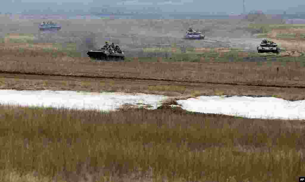 Ukrainian army vehicles drive through the fields of Debaltseve as fighting intensifies between government and rebel forces for control of this key railway hub, eastern Ukraine, Feb. 2, 2015.