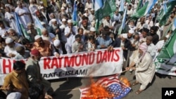 Supporters of the religious and political party Jamaat-e-Islami burn the U.S flag during a protest rally against American Raymond Davis in Karachi, February 11, 2011.