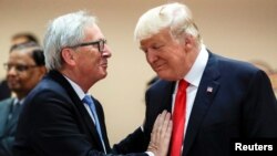 FILE - U.S. President Donald Trump, right, talks with European Commission President Jean-Claude Juncker, left, before a working session at the G-20 summit in Hamburg, Germany, July 8, 2017.